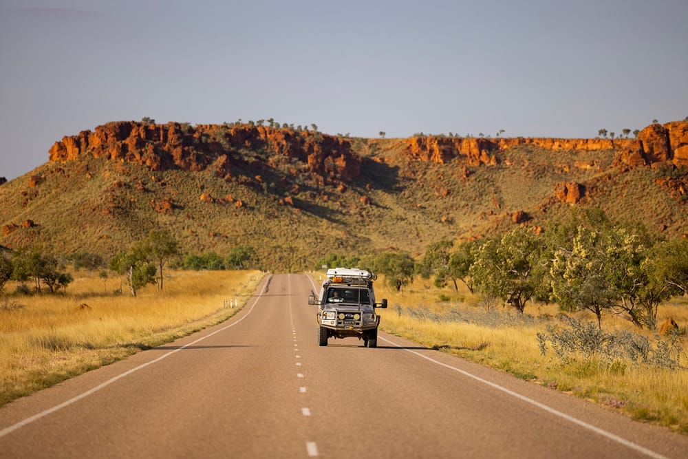 Car driving down Gibb River Road in The Kimberly Region of Western Australia.