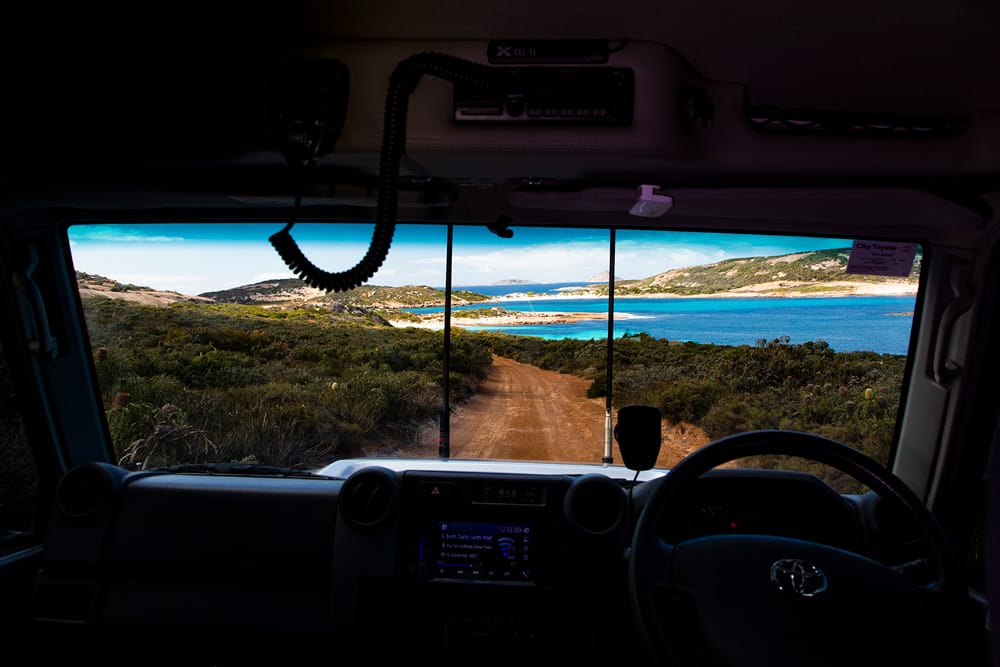 Backpackers driving a 4WD down the Duke of Orleans Bay.