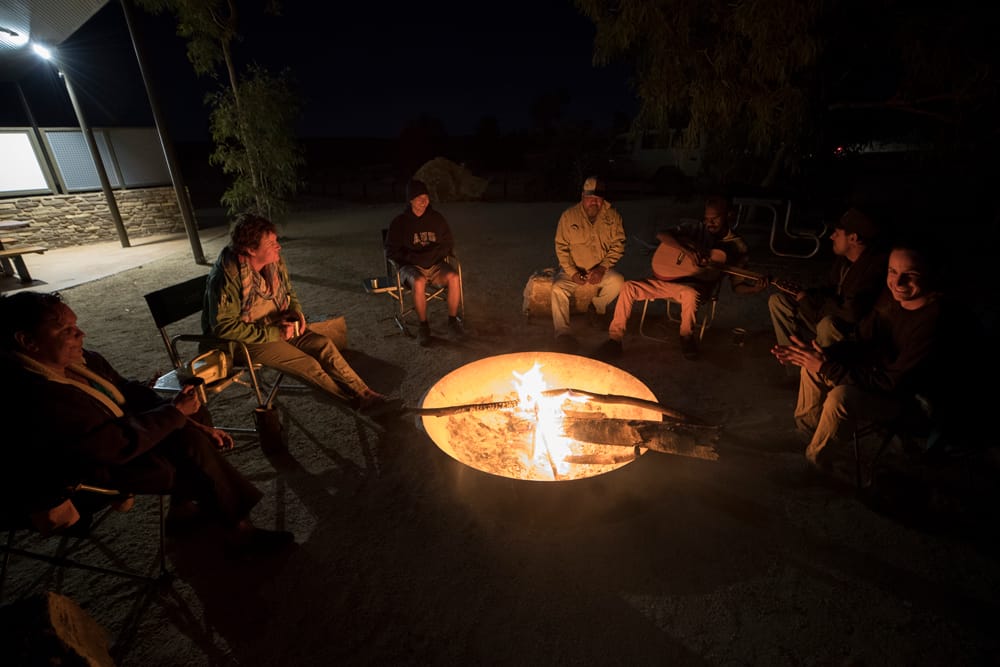 Group of backpackers around a fire camping at Mimbi Caves, Fitzroy crossing.