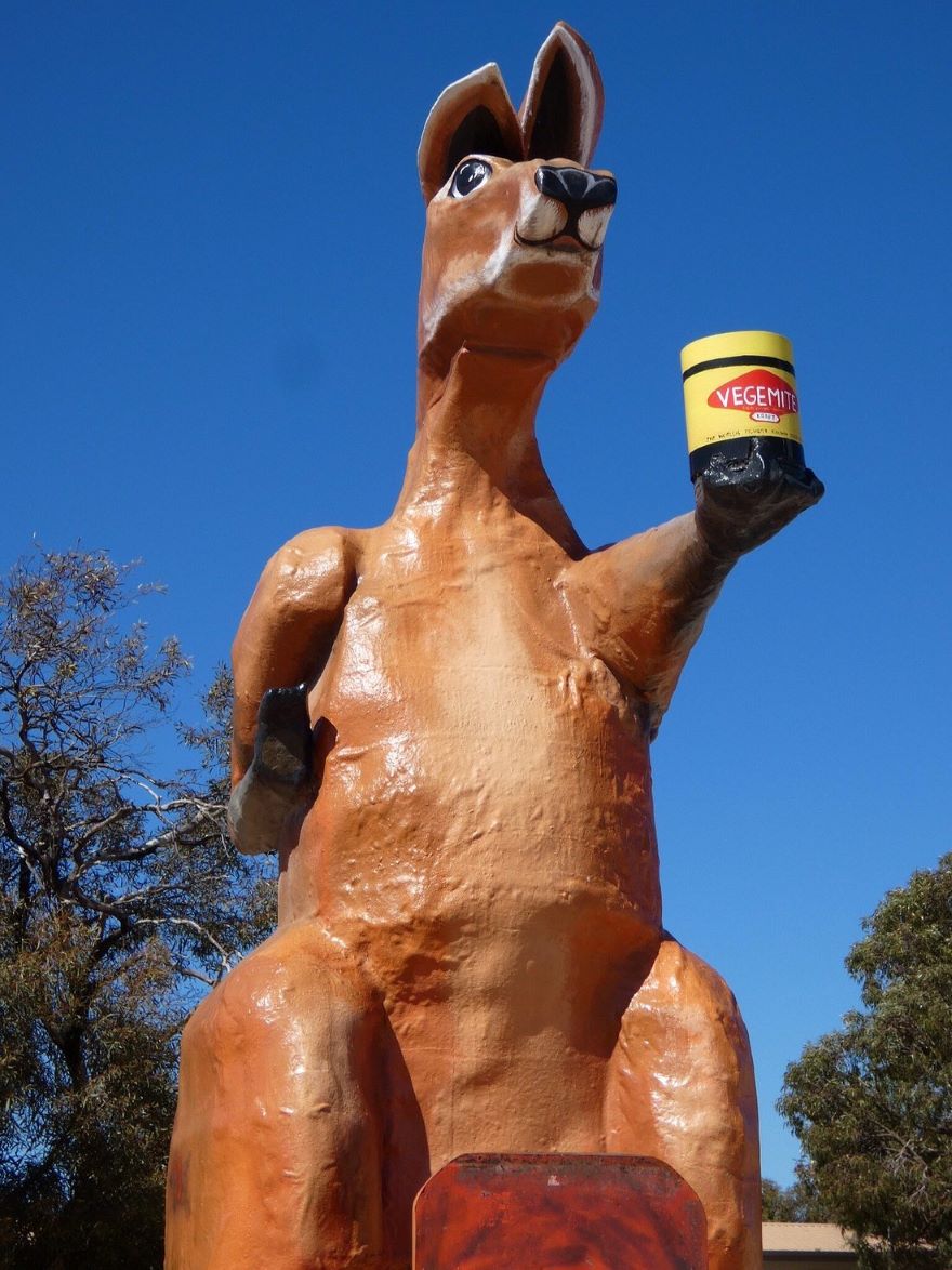 A big red kangaroo statue holding a jar of vegemite