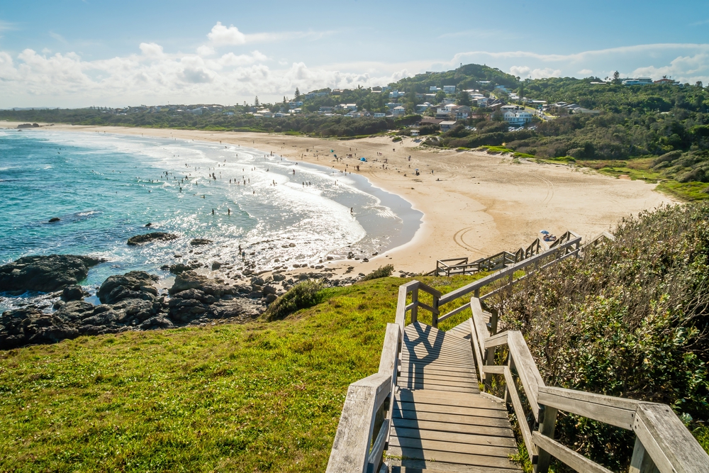 A wooden path leads down to the beach