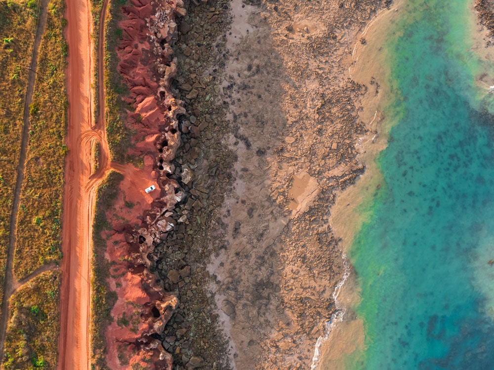 Aerial view of the red sands and turquoise waters off Gantheaume Beach, Broome.