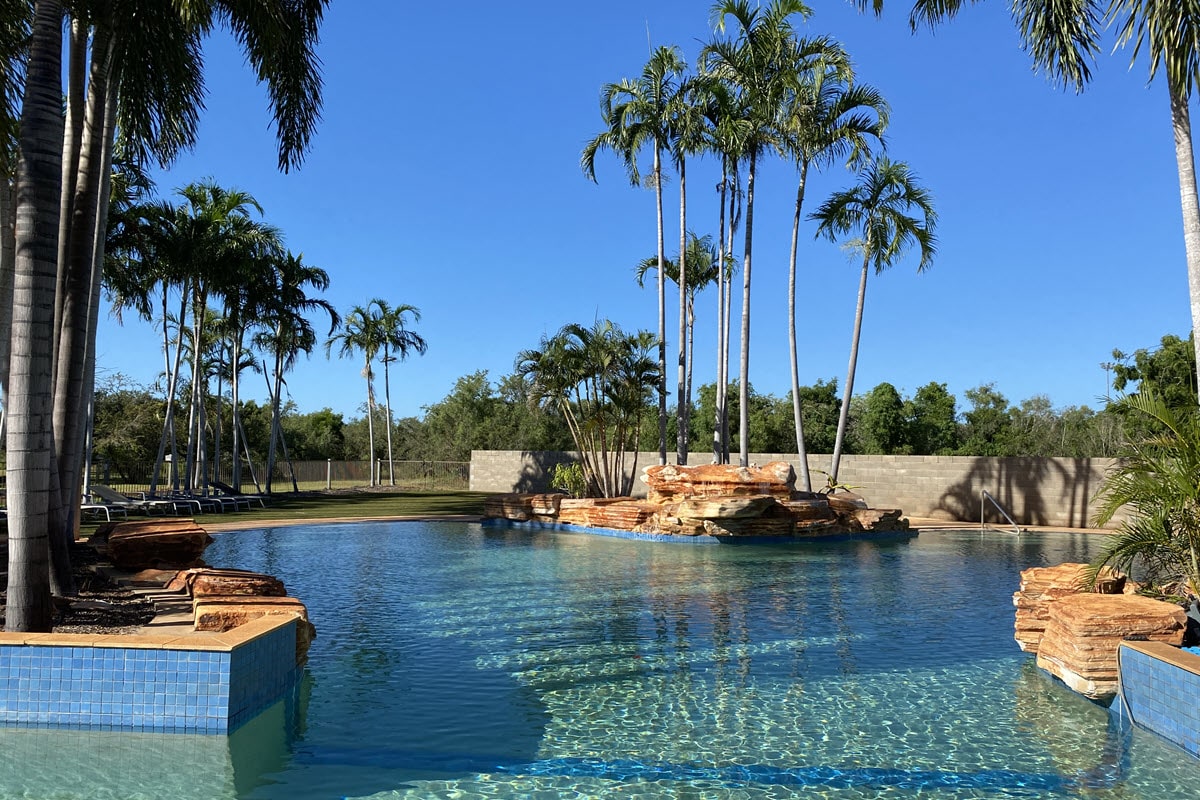 Shot of pool and palm trees at Broome Caravan Park in WA's northern Kimberley region.