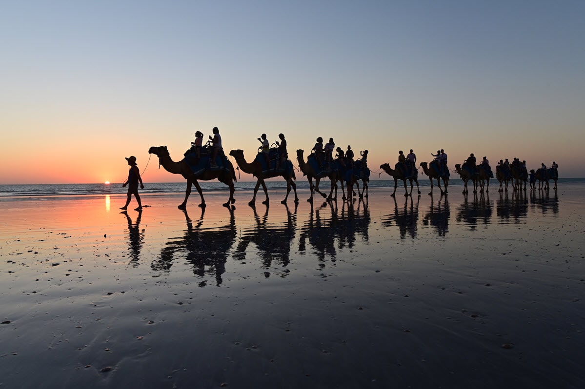 Tourists enjoying a beach camel ride down Cable Beach in Broome, Western Australia.