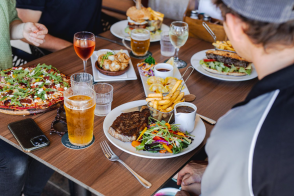 A table of people with food and drinks