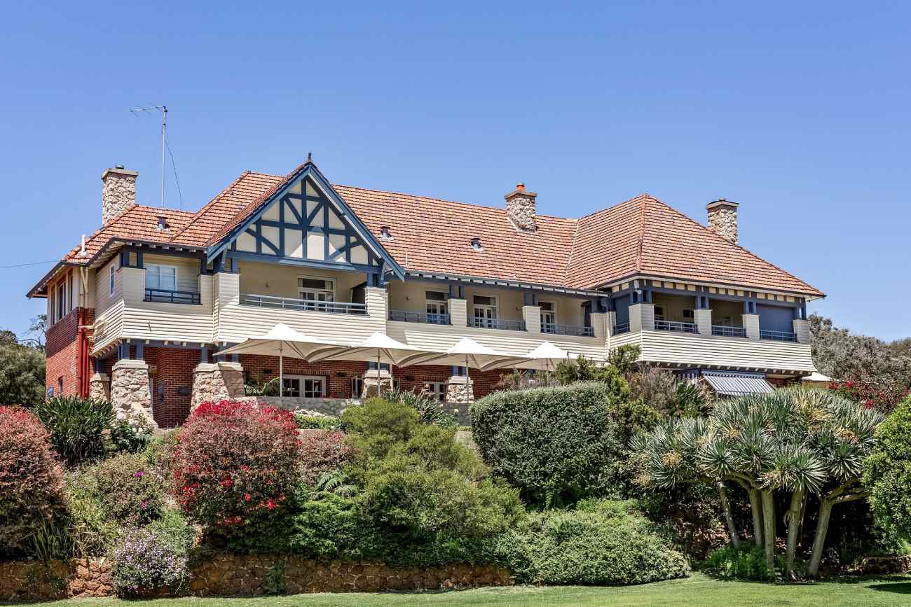 A hotel surrounded by bushes and trees