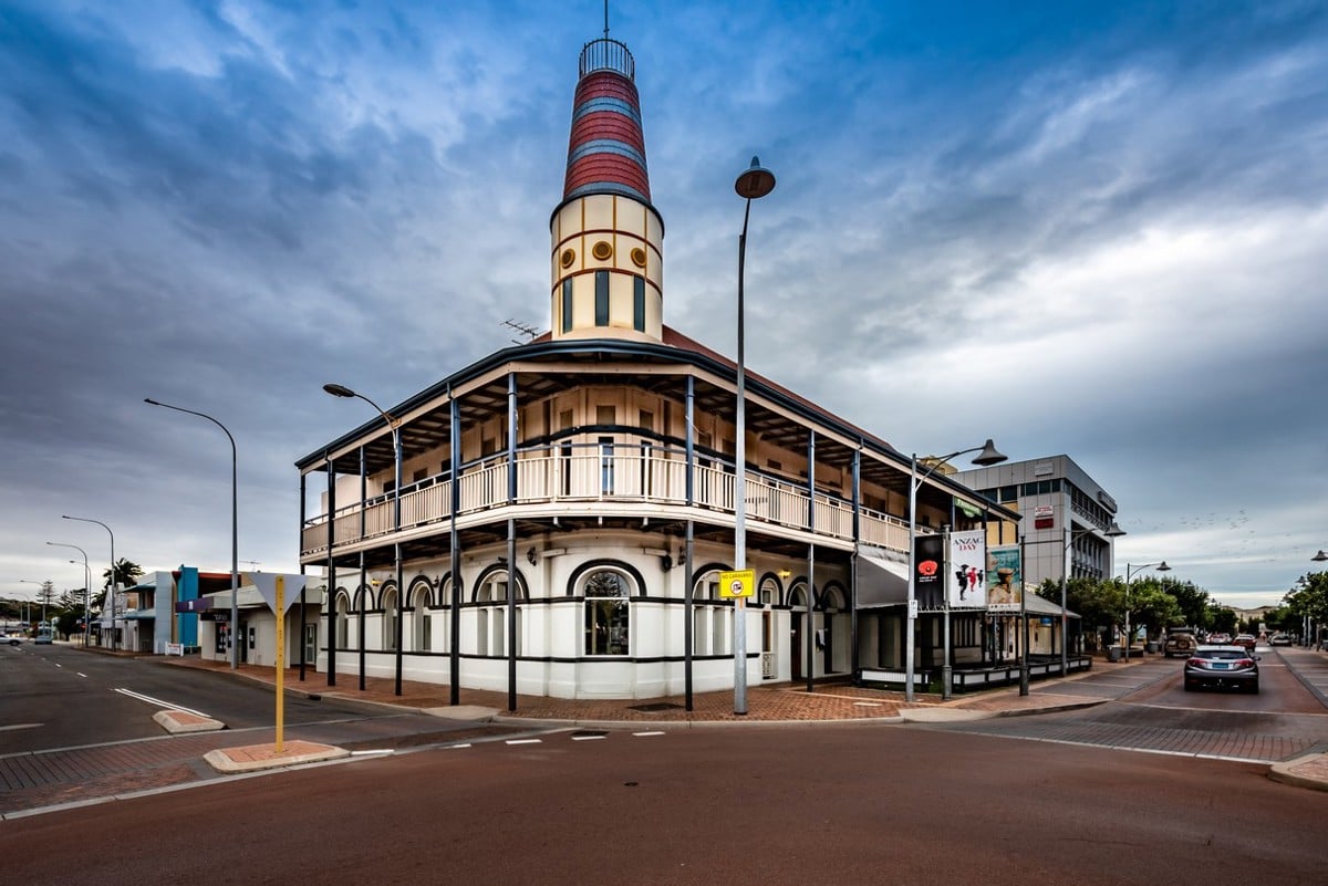 A hotel on the corner of a road