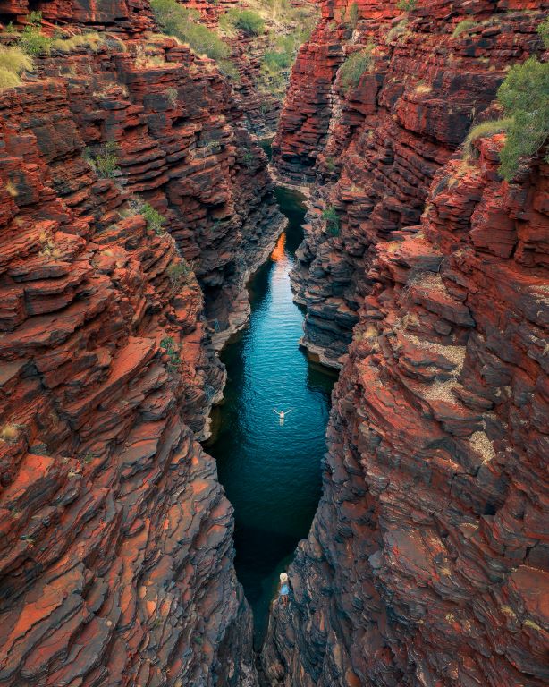 A man floating in the water in a gorge