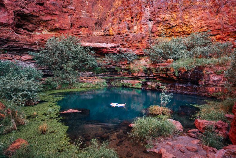 A man floating in a pool in Karijini National Park