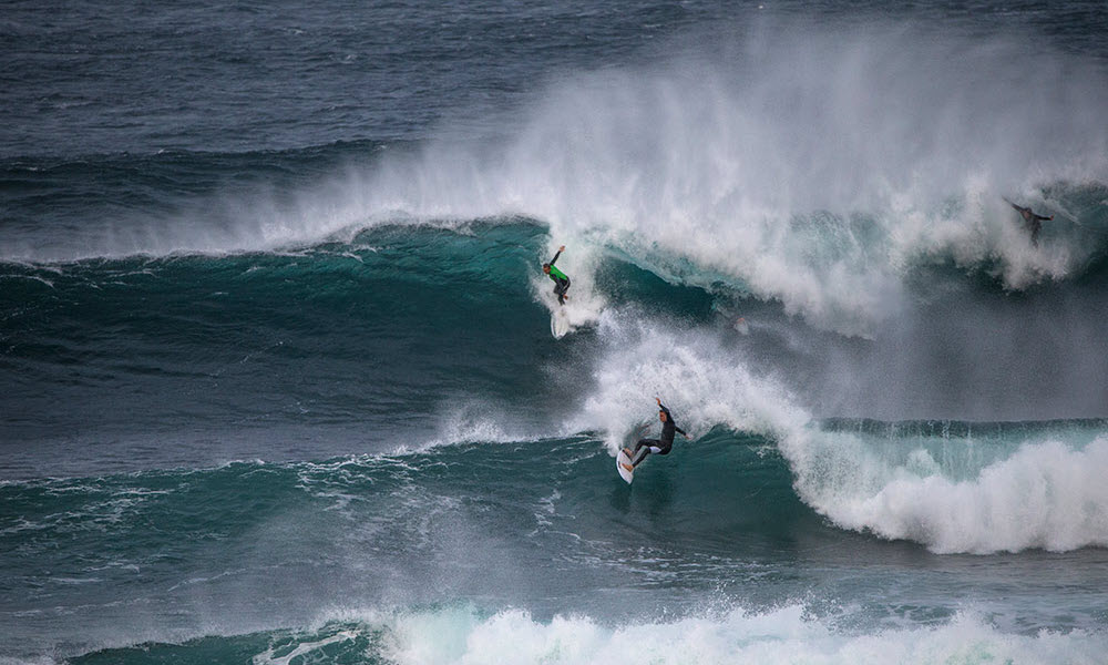 surfing a wave in margaret river