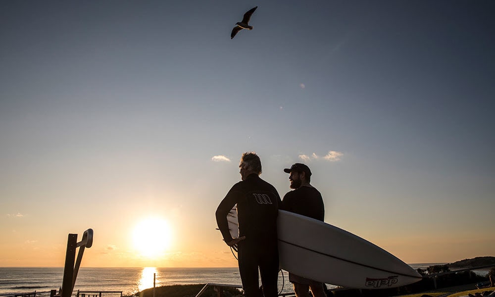 Surfers standing at surfers point in margaret river