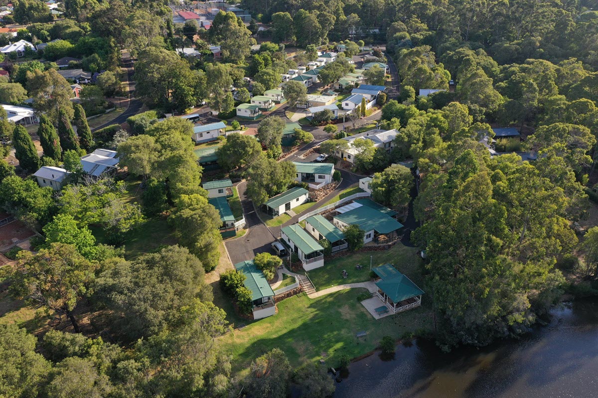 Aerial view over Riverview Tourist Park, lush green trees and waterways in Margaret River, WA.