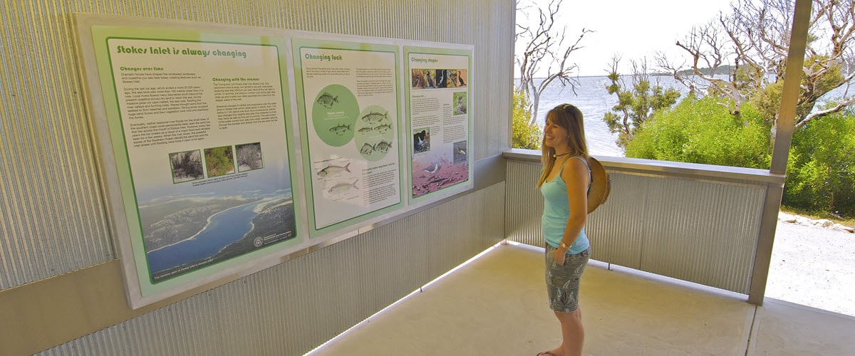Woman reading info boards at Stokes National Park in Esperance, WA.