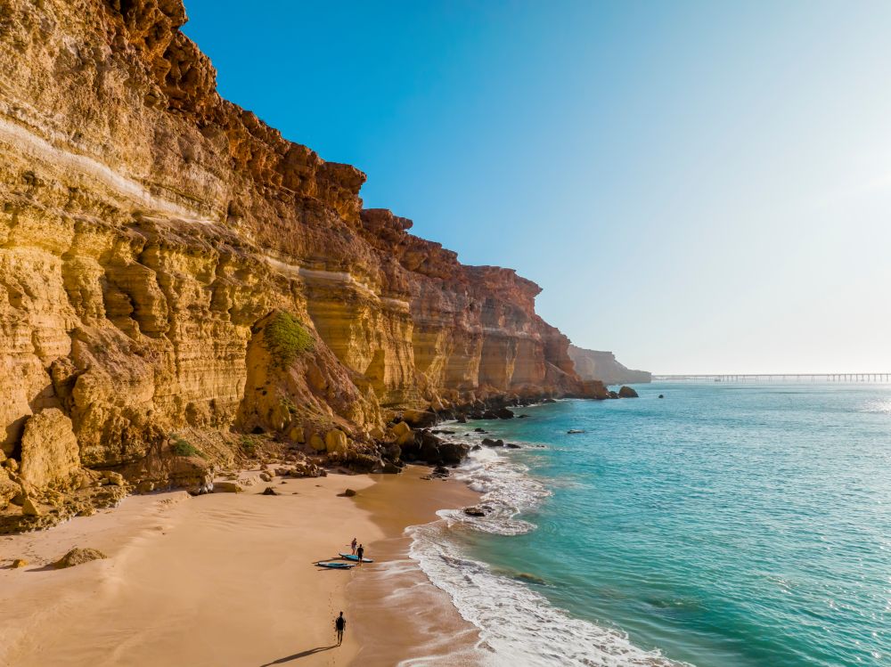 People getting ready for a surf in the ocean.