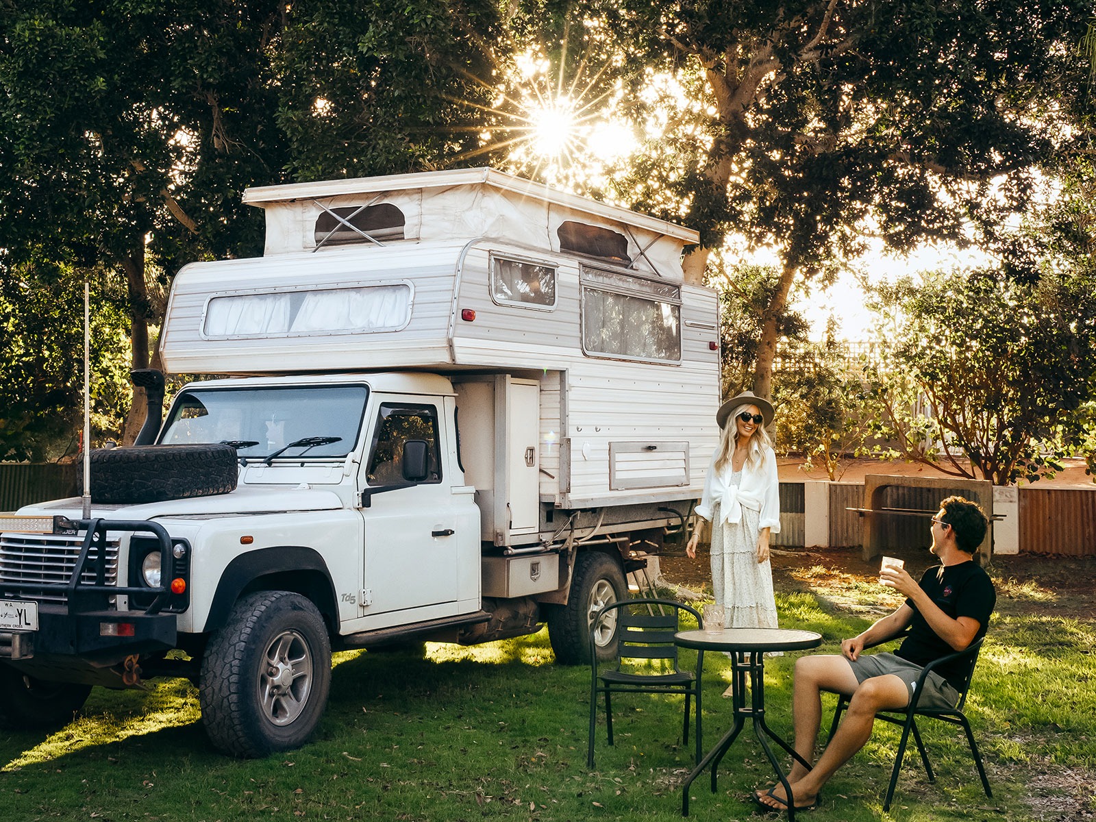 Couple sitting by their caravan at a caravan park