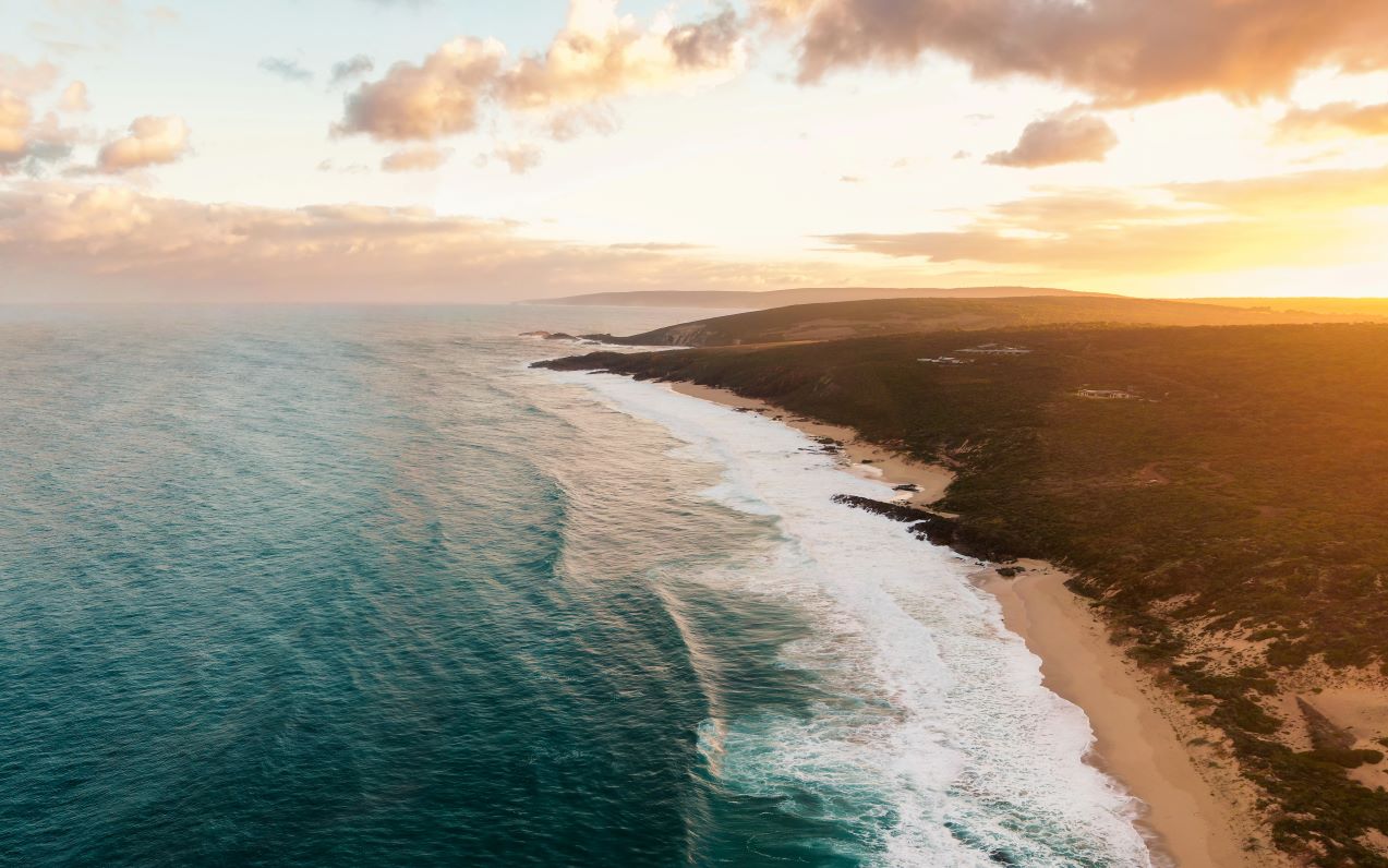 A drone image of the ocean crashing onto the beach