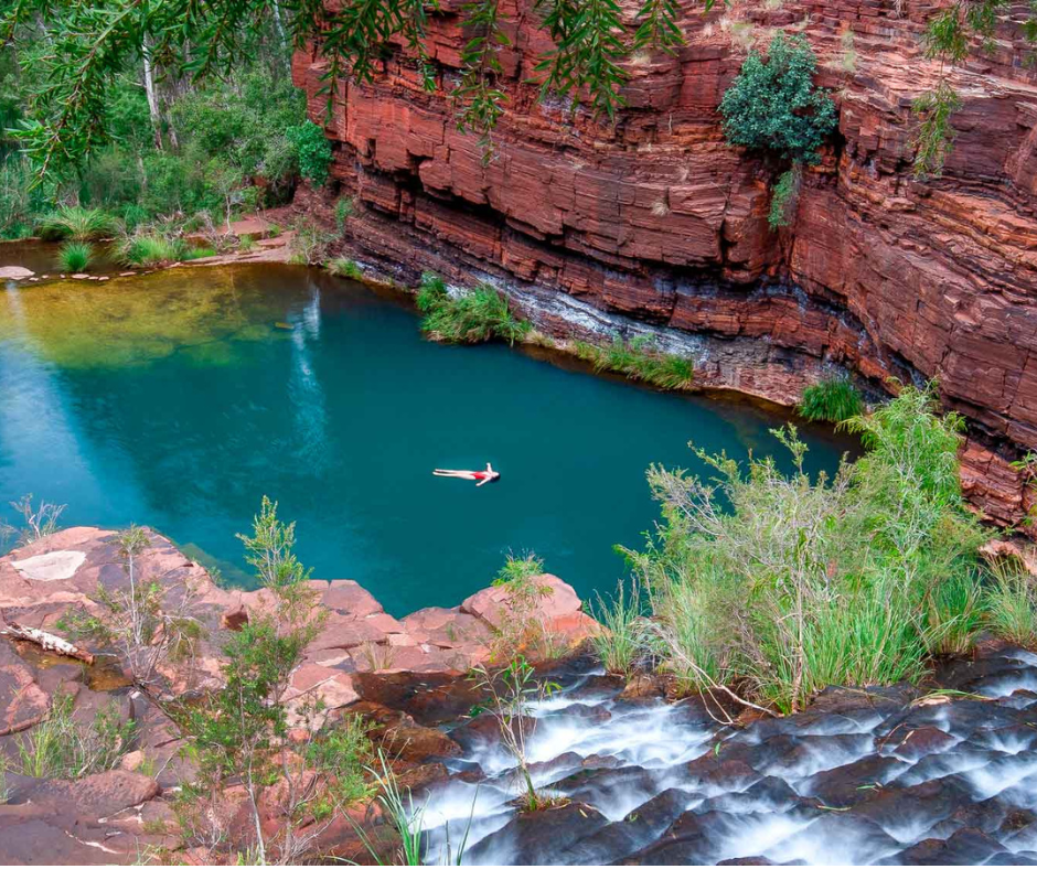 A woman floats in pool within a gorge